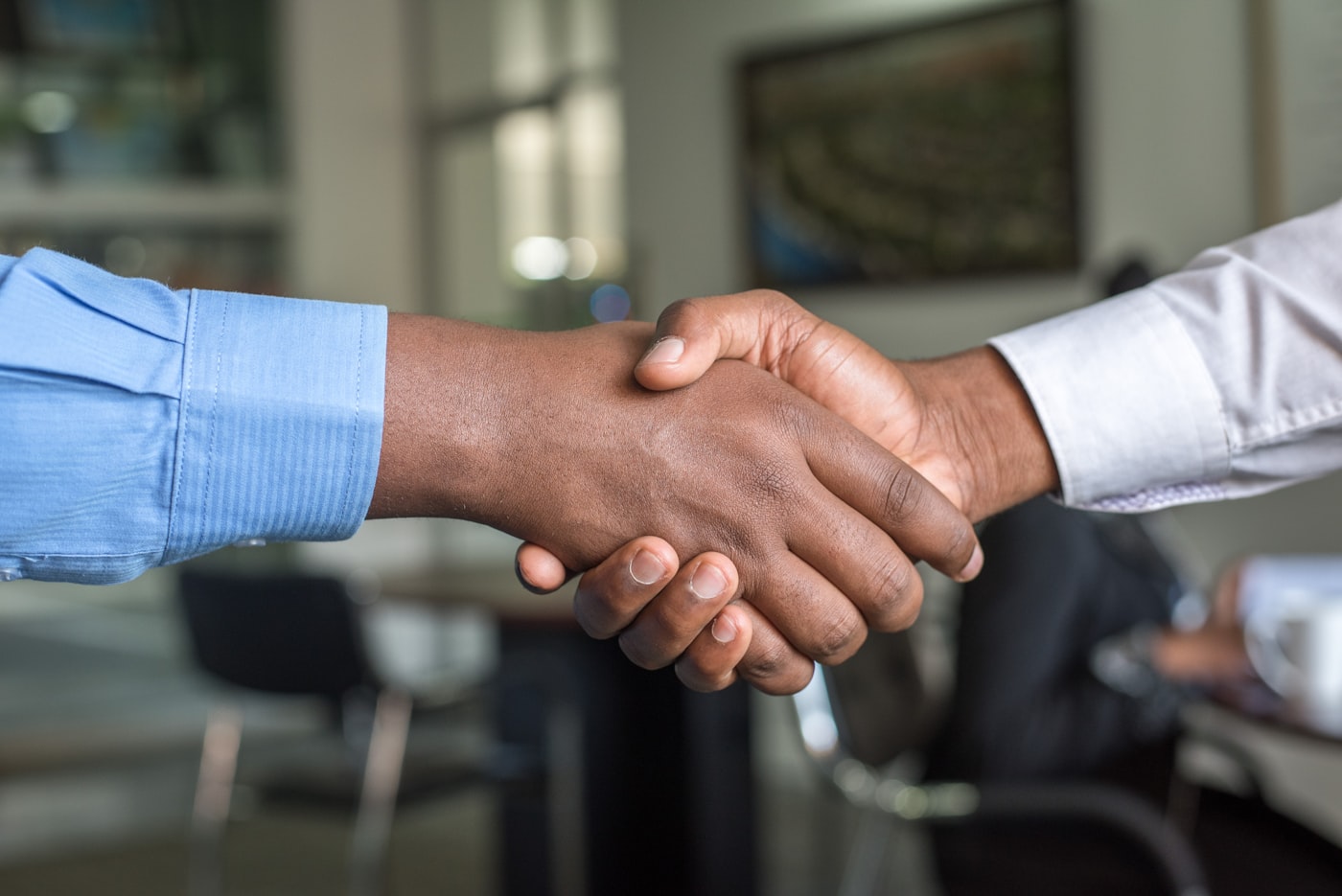 An employer welcoming a new hire with a handshake